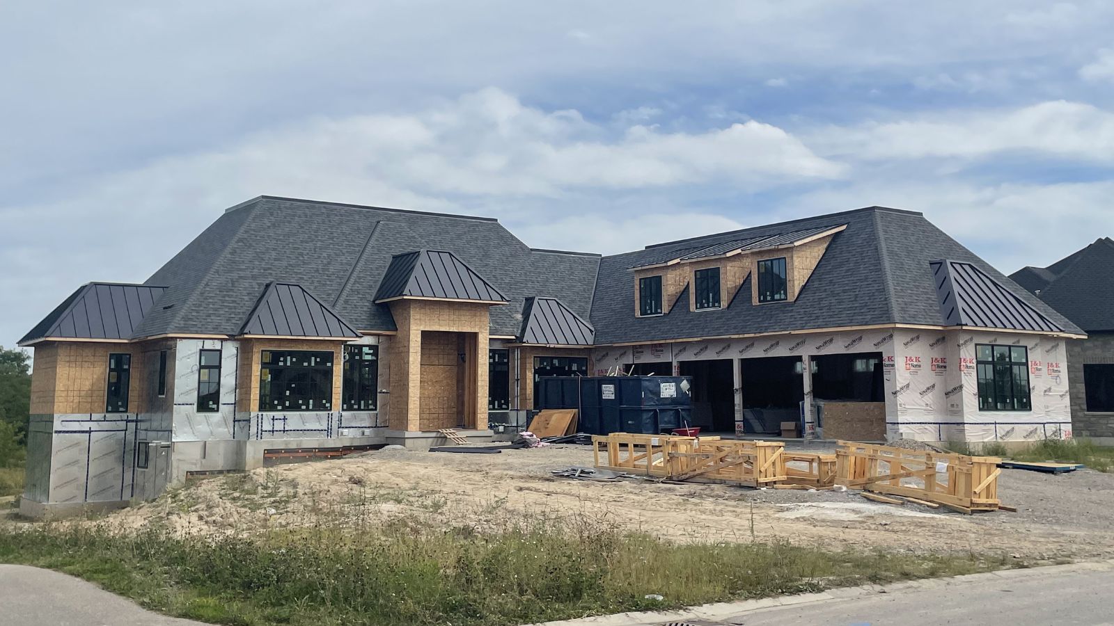 Luxury-New-Build-Roofing-System-with-Shingles-Standing-Seam-Flat-Roof-front-of-house-from-road