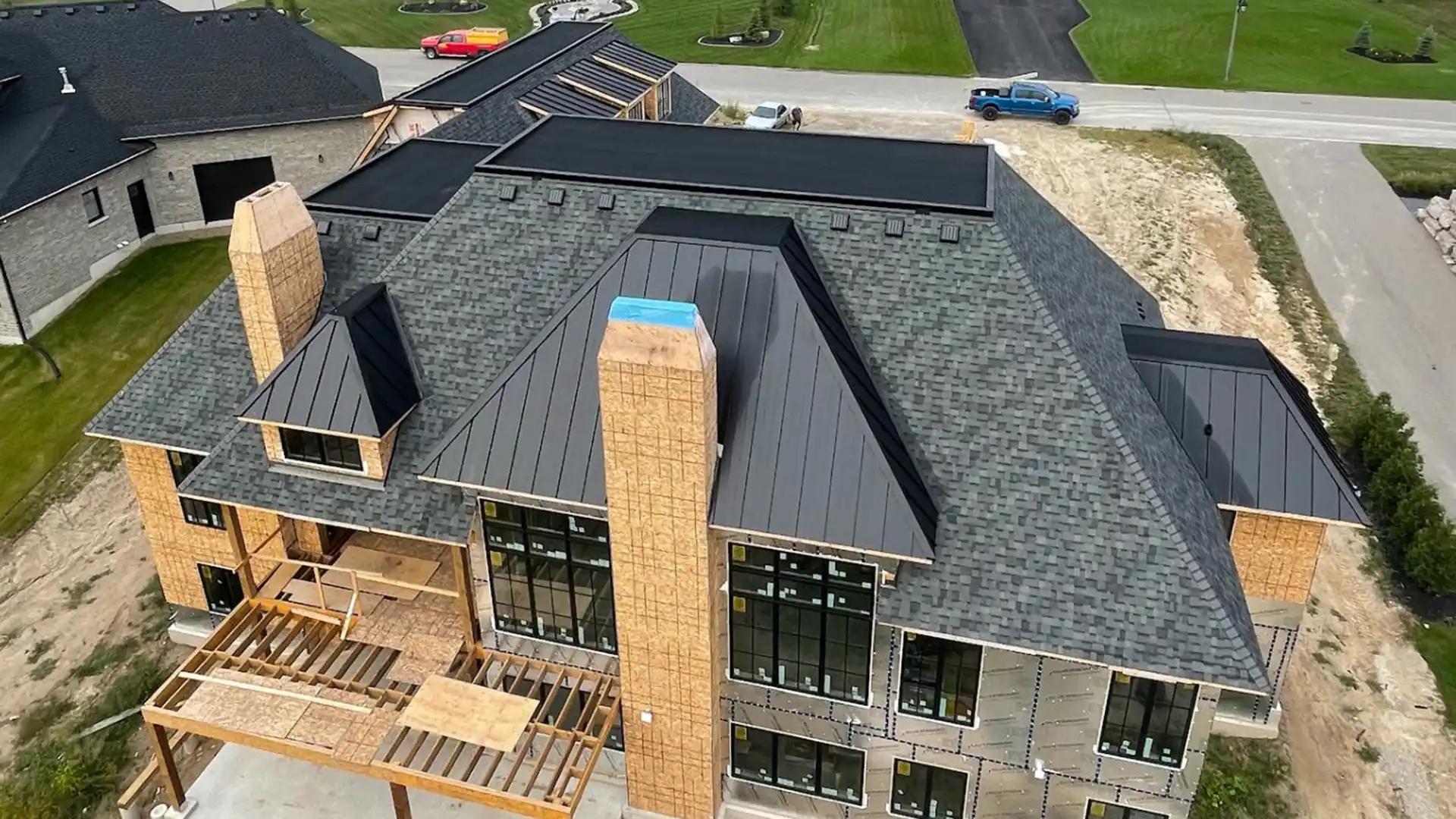 Luxury New Build Roofing System with Shingles, Standing Seam & Flat Roof